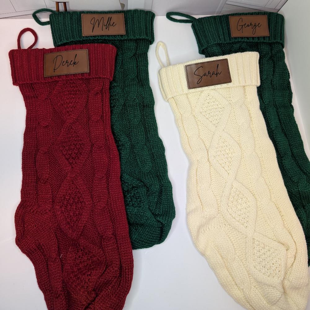Close-up of the Personalized Knit Christmas Stocking, showcasing the classic cable knit pattern and engraved name patch.