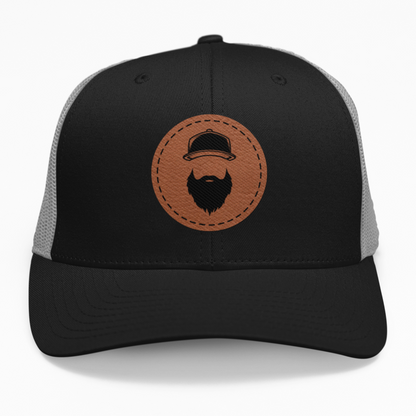 Preview of the 'Bearded Guy' leatherette patch on a custom hat, showing how the bearded face design looks on an adjustable snapback.