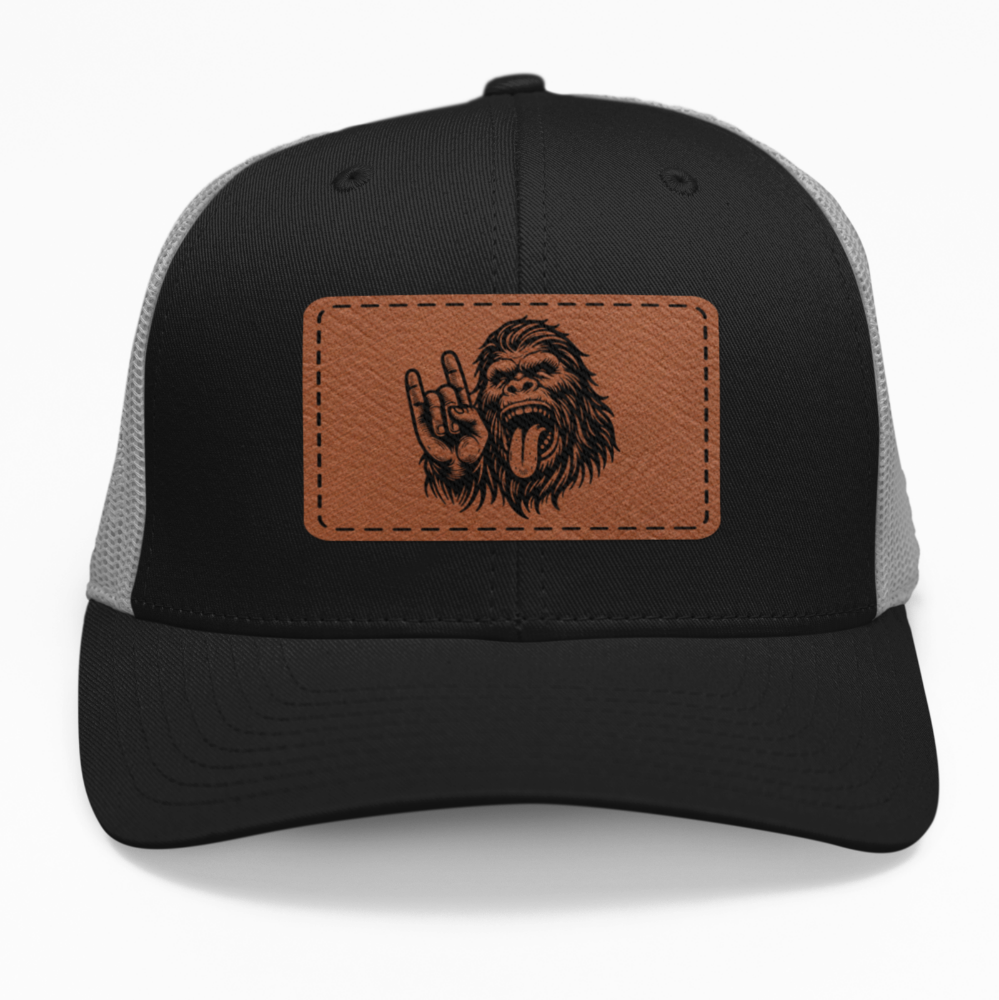 Preview of the 'Bigfoot Rock Out' leatherette patch on a custom hat, showcasing the fun and bold design on an adjustable snapback.