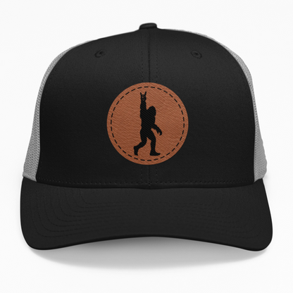 Preview of the 'Bigfoot Silhouette Rock Out' leatherette patch on a custom hat, showcasing the bold and fun design on an adjustable snapback.