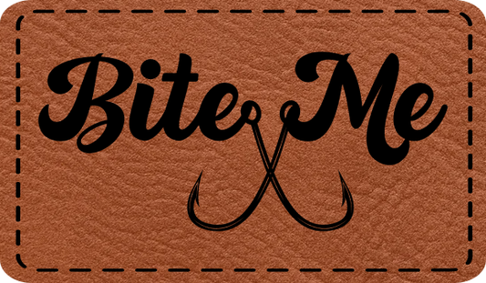 Close-up of the 'Bite Me' leatherette patch with two fish hooks, perfect for fishing enthusiasts who love humor.