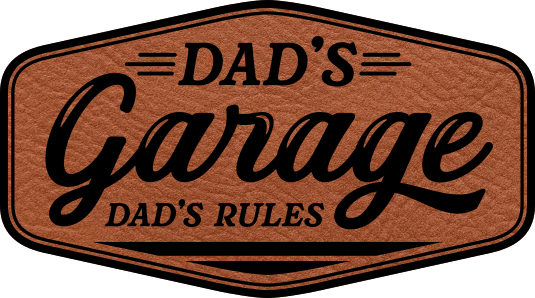 Close-up of the "Dad's Garage Dad's Rules" leatherette patch, featuring bold text and a fun design.