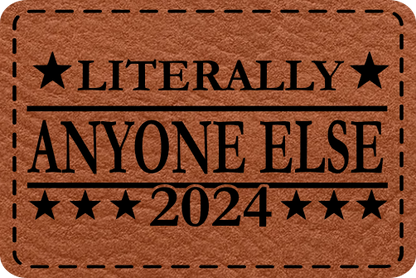 Close-up of the "Literally Anyone Else 2024" leatherette patch featuring bold political protest text.