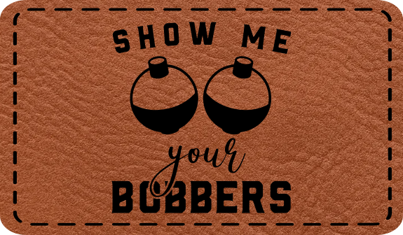 Close-up of the "Show Me Your Bobbers" leatherette patch featuring playful fishing-themed text.