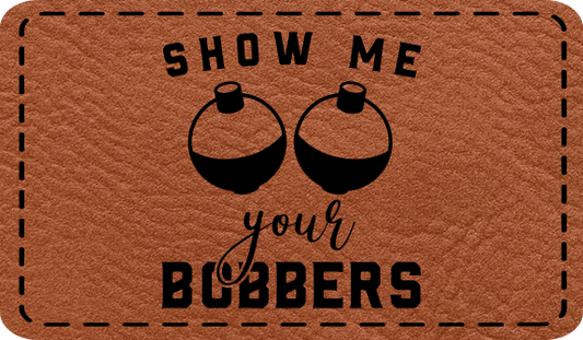 Close-up of the "Show Me Your Bobbers" leatherette patch featuring playful fishing-themed text.