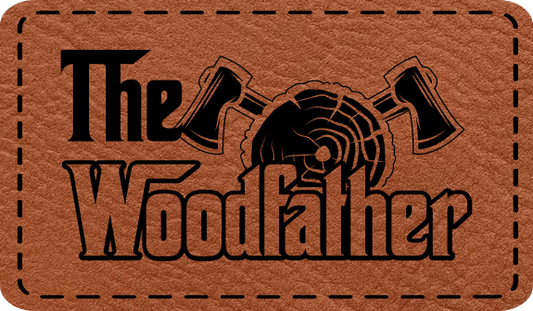 Close-up of the "Wood Father" leatherette patch featuring crossed axes and rugged text.